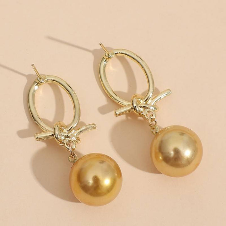 Boucles d'oreilles créoles en perles dorées