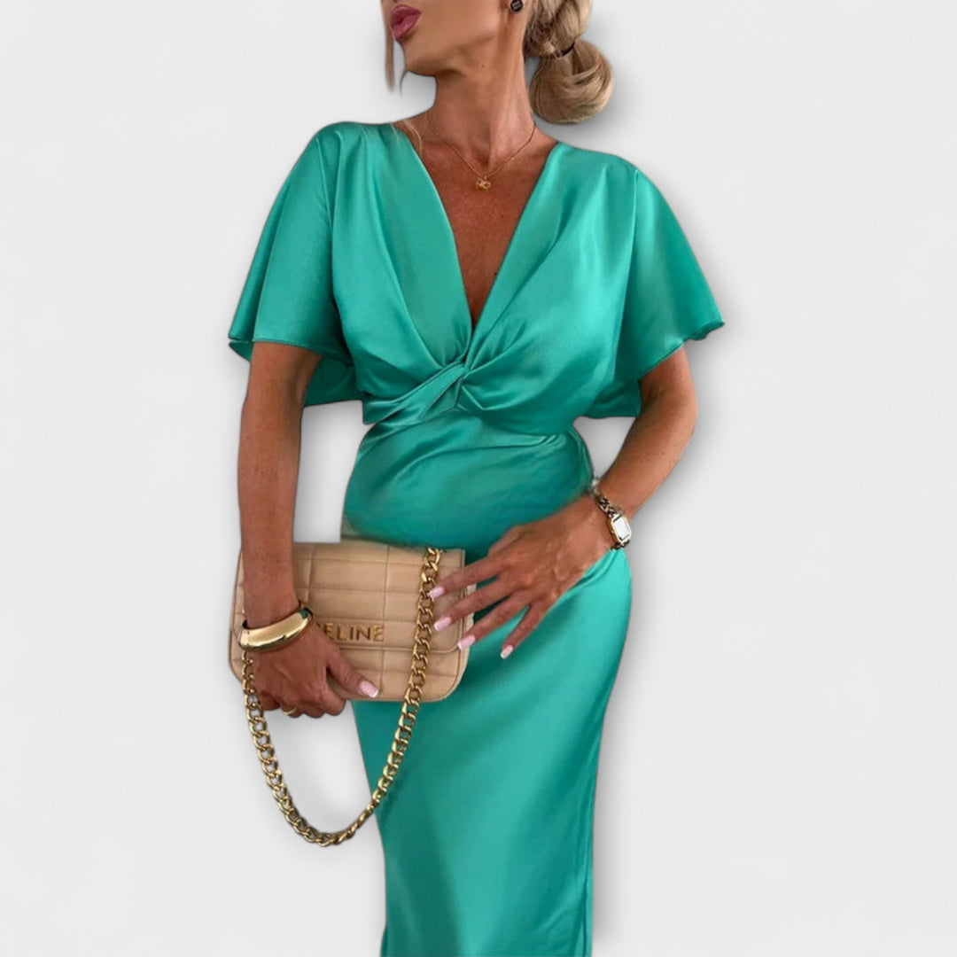 Sable - Robe maxi ajustée en satin uni à col en V avec nœud croisé