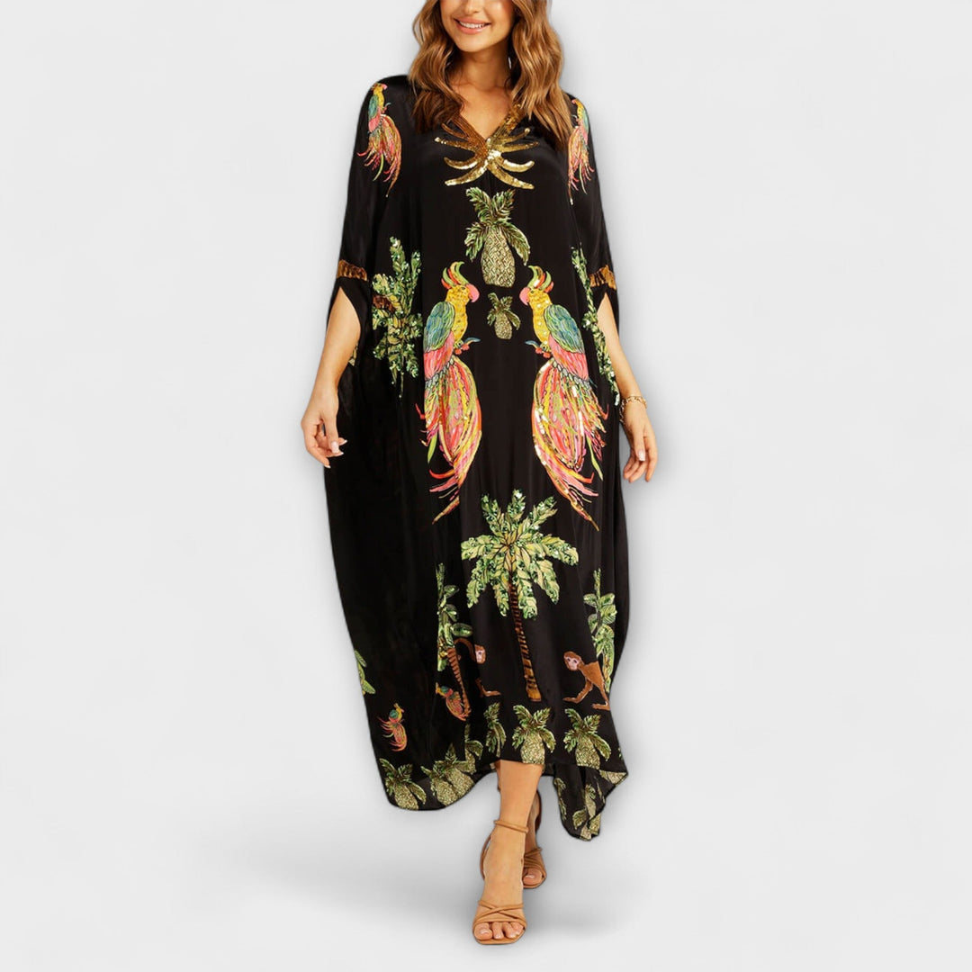 Linda - Robe accroche-regard aux épaules asymétriques et imprimé palmier