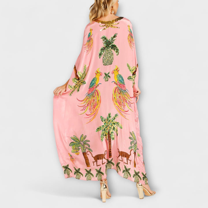 Linda - Robe accroche-regard aux épaules asymétriques et imprimé palmier