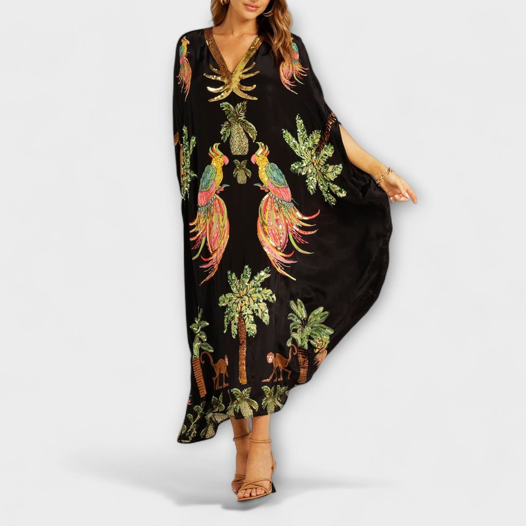 Linda - Robe accroche-regard aux épaules asymétriques et imprimé palmier