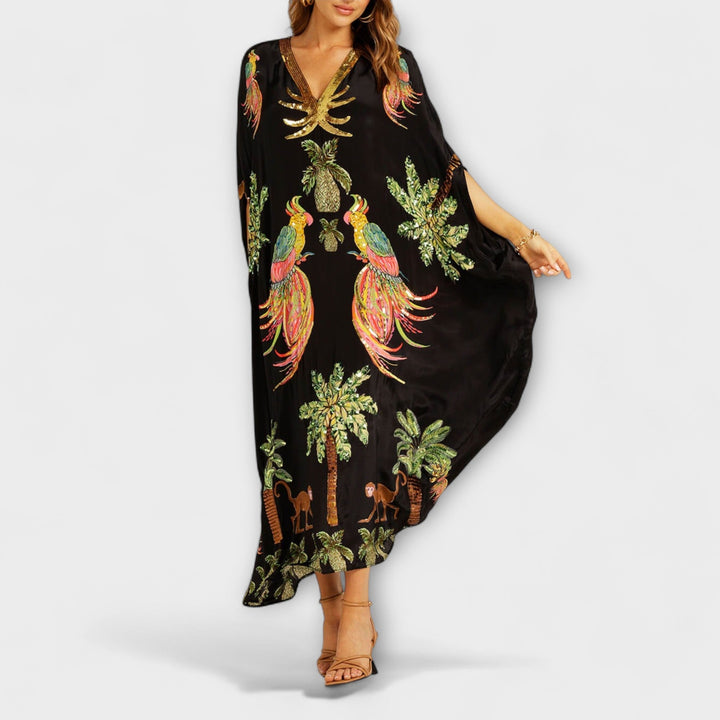 Linda - Robe accroche-regard aux épaules asymétriques et imprimé palmier