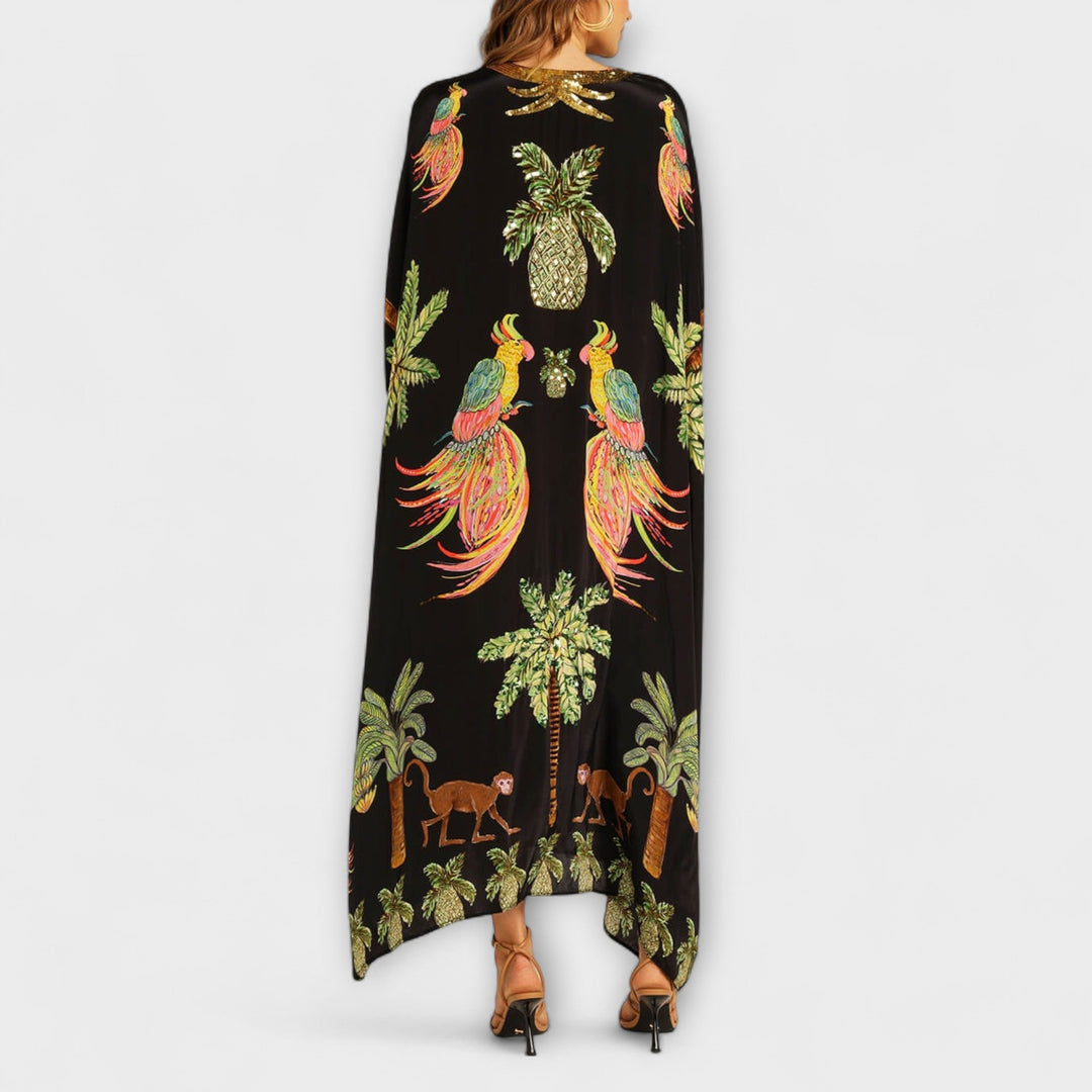 Linda - Robe accroche-regard aux épaules asymétriques et imprimé palmier