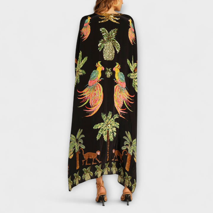 Linda - Robe accroche-regard aux épaules asymétriques et imprimé palmier