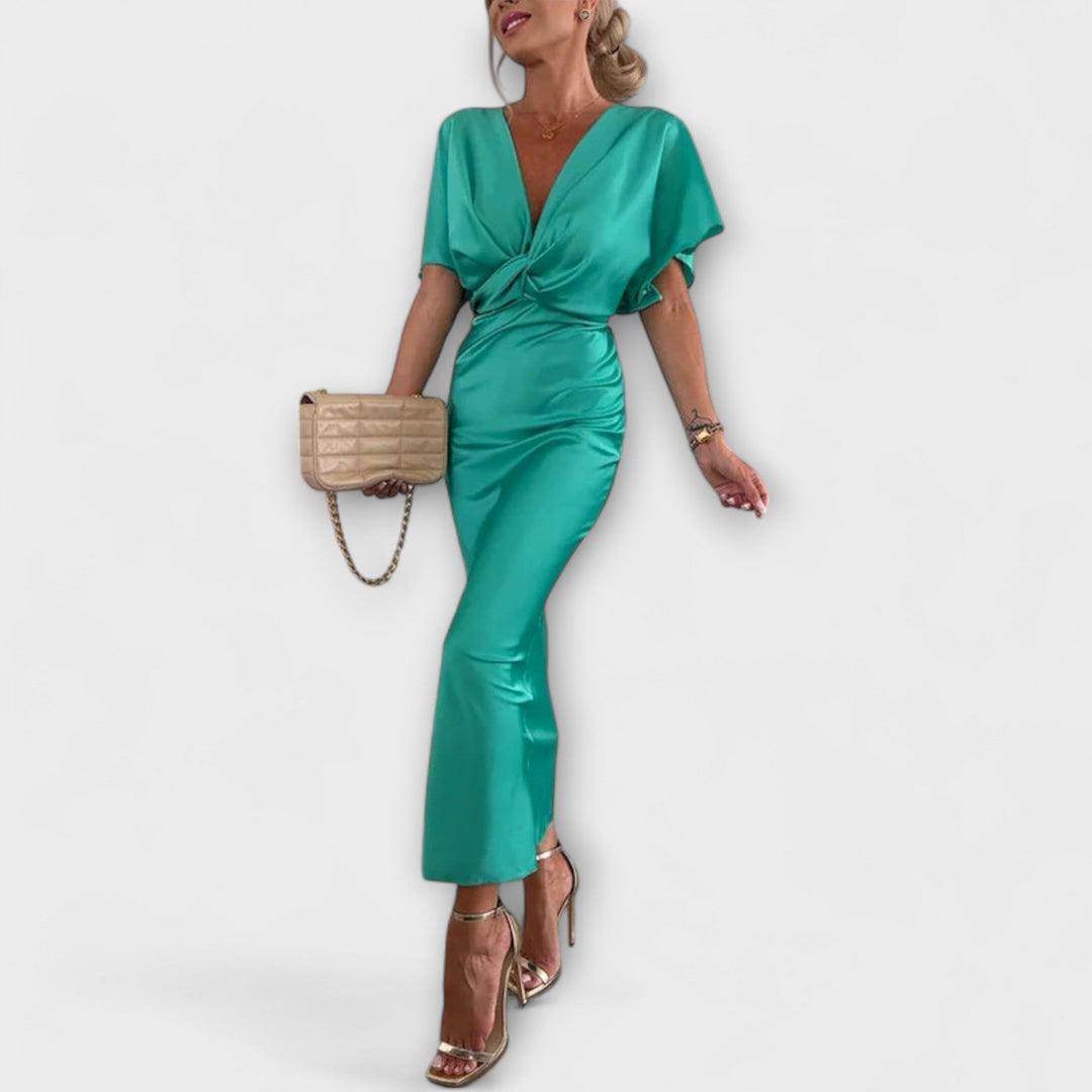 Sable - Robe maxi ajustée en satin uni à col en V avec nœud croisé